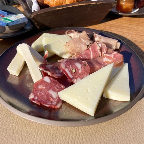 Greek cheeses and cold cuts plate with Syros salami, Mykonos louza, Santorini chloro, Anafi lagaro, 