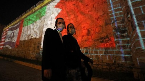 The flags of US, Israel, United Arab Emirates, and Bahrain are projected on the Jerusalem’s Ol