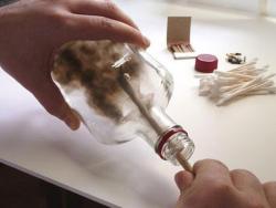sixpenceee:  The Bottled Smoke Artwork of Jim Dingilian.  He uses candle smoke to paint picture-perfect images on the inside of empty bottles. After laying a coat of soot on the lining of the bottles, the artist wipes and etches away with skewers and