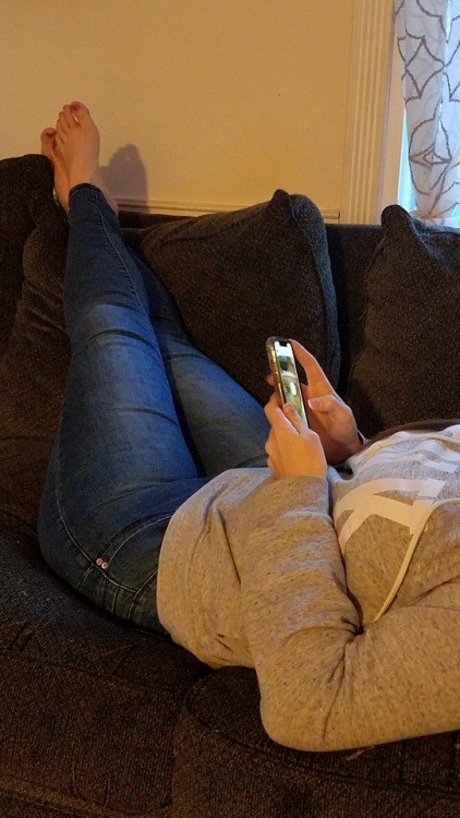 My pretty wife just chillin barefoot on the couch with her phone.