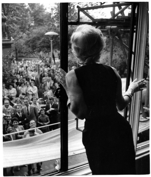 Marilyn Monroe Waving to fans outside the Savoy Hotel, London. 1956