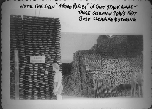 peashooter85:German POW’s cleaning and stacking captured German rifles for arsenal storage, World War II.  Note, sign on one stack reads “44,000 rifles”.