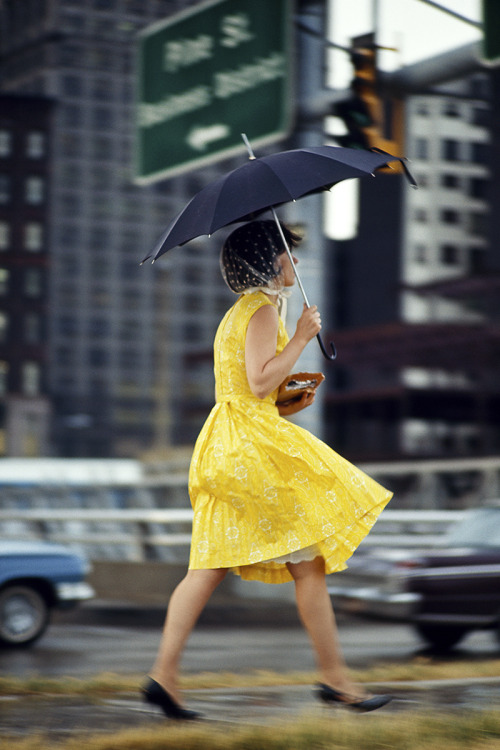 The girl in a yellow dress and the blustery day / St. Louis, Missouri; 1965.