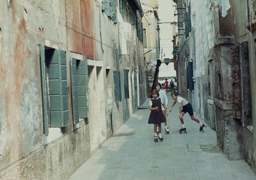 vintageeveryday:Children roller skating in a narrow street in Venice, 1960s. Photographed by Giulio 