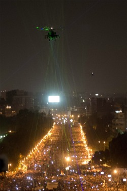 morphinginthepuhsea:  sunnnyali:  Protesters in Egypt pointing lasers at military helicopters.   shits REAL