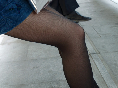 Close up of legs in black pantyhose caught in the street.Woman in pantyhose