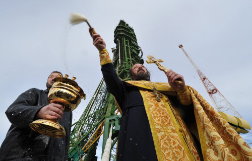 speciesbarocus:Orthodox priests blessing Soyuz spacecrafts at the Baikonur cosmodrome, Kazakhstan. &