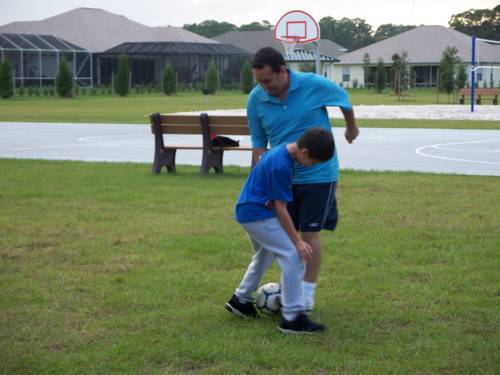 Playing soccer with their uncle (jugando futbol con el tio )