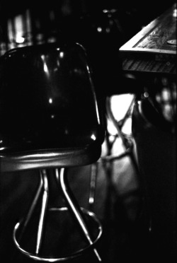 fromme-toyou:  6th street bar stool. Austin, Texas Minolta SRT101 / FujiFilm Neopan1600 
