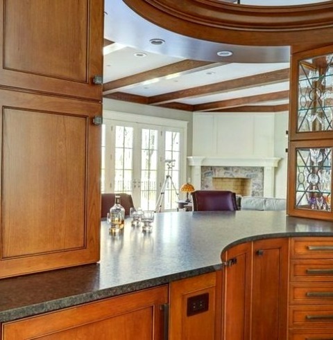 Home Bar - Galley A Large, Elegant Galley With A Drop-in Sink, Medium-tone Wood Cabinets, Granite Countertops,