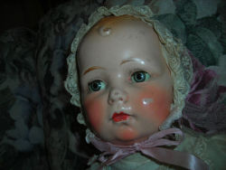 hazedolly: Sad, spooky, lovely. Shabby composition baby doll with tin eyes - circa 1930s. Photo source: eBay.com 