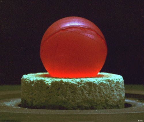 mdwaxx:Plutonium pit core from a nuclear weapon, glowing under its own power.