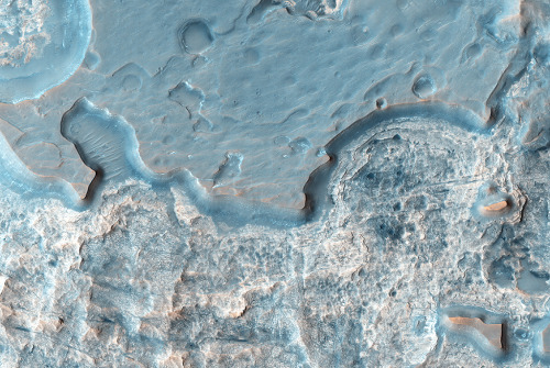 Hydrae Chasma is a deep, circular depression approximately 50 kilometers across, situated between Ju