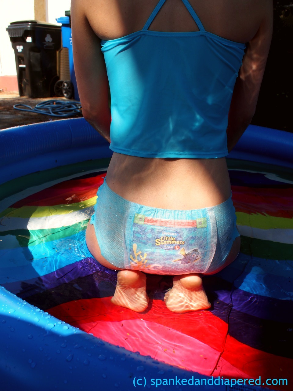 alexinspankingland:  Adorable little Dorothy was outside playing in the pool…without