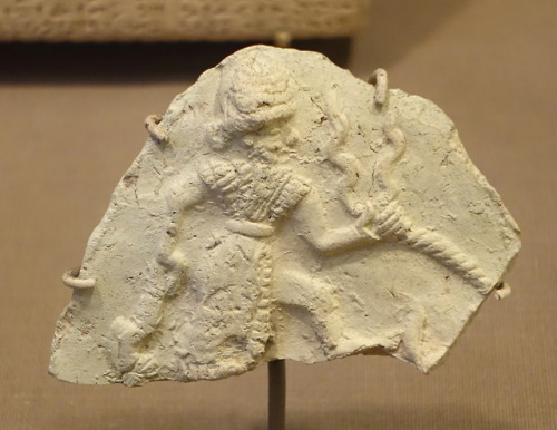 Ancient Mesopotamian baked-clay plaque depicting the storm god Ishchali.  Artist unknown; ca. 2000-1