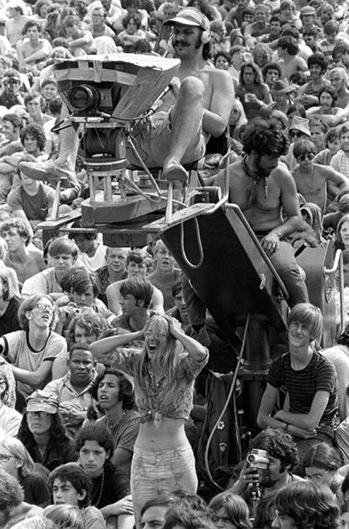 nostalgia-eh52:1969 A cameraman sitting above the crowd at Woodstock 