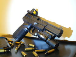 gunrunnerhell:  FN Five-seveNOlder generation model; note the lack of the front slide serrations which were added to the curren MK2 model. You don’t seen slide mounted red dots too often on a Five-seveN. The mounts replace the rear sight, which some