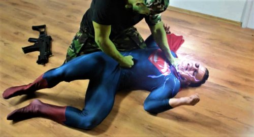 Superman is choked and gut-punched!Source