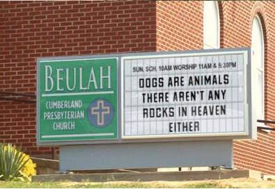 Two churches located across the street from each other.  At least the Catholics have a sense of humor.