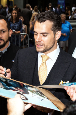 vikander:   Henry Cavill signing autographs