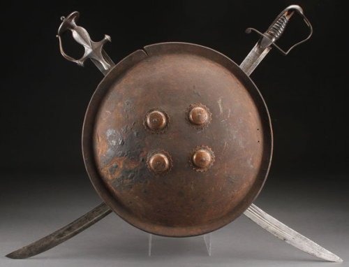 victoriansword:Decorative shield with crossed swords, featuring actual weapons! The sword on the lef