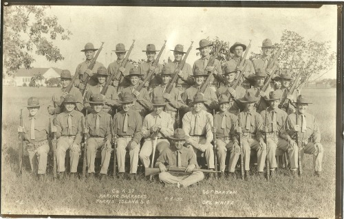 A platoon of US Marines poses with their Springfield rifles, Parris Island, 1932.The Marine at the f