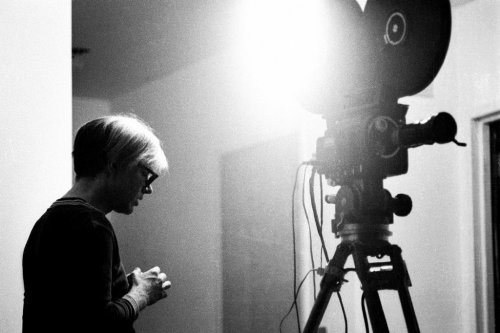 steroge:  Andy Warhol with 16mm movie camera, 1965 Photo by Billy Name