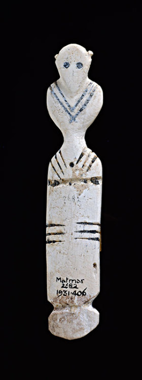 Bone FigureTop decorated with human figure carved in round; small high ears, hollowed black-filled e