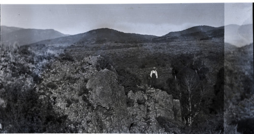 As Men Emerge.  Found Medium Format Film Negative. A mysterious landscape photograph showing three m
