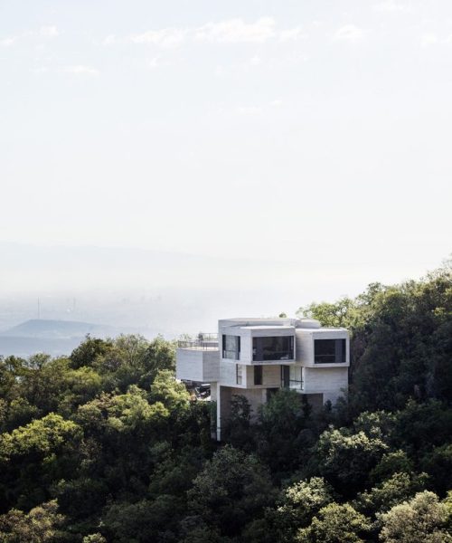 archatlas:  Ventura House in MonterreyThis house by Mexican architect Tatiana Bilbao comprises a cluster of five-sided concrete blocks that emerge from a forested hillside to offer panoramic views towards the city of Monterrey. The uneven terrain informed