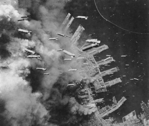 ironwarriors: Incendiary bombs fall from a B-29 Superfortress on the already burning piers of Kobe, 