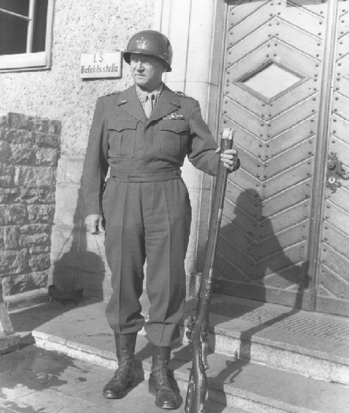 Gen. George S. Patton posing with German flintlock jager rifle after the capture of Frankfurt, March