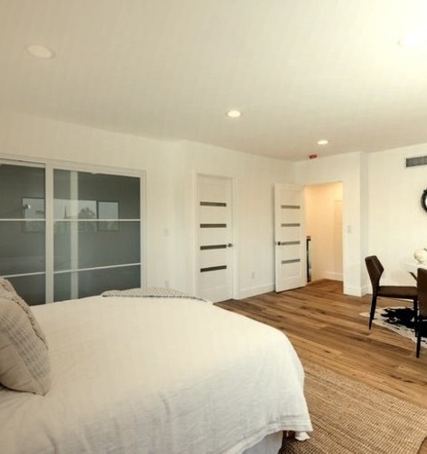 Guest BedroomInspiration For A Huge, Modern Guest Bedroom Renovation With White Walls, A Fireplace, And
