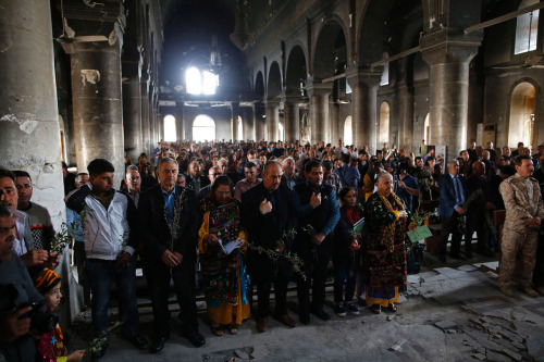 Assyrian Christians from Bakhdida attend the first Palm Sunday service in the heavily damaged Church