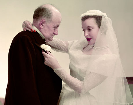 vintagebrides:  Father of the bride gets a boutonnière.  April 1950, from the Condé Nast Archive.