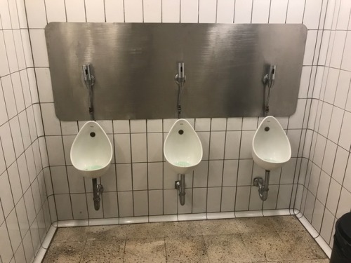 Tiny urinals in the basement of the Flagey bar in Ixelles in Brussels. The steel doors just have th