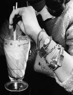 vintagegal:  Closeup of teenage girl’s wrist covered with six different identification bracelets which are as popular as the milk shake she is enjoying at a soda fountain. Photographed by Nina Leen, 1944 