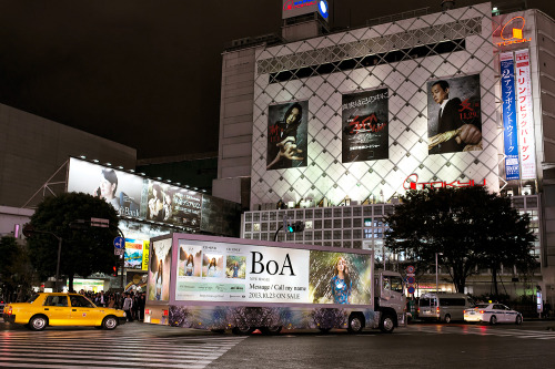BoA promo truck driving through Shibuya Scramble at night.