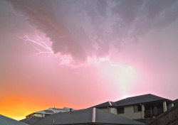 artisjustfrozenmusic:  Went out the back to take some photos of storm clouds.  Then this happened.  Lightening and the sunset.  