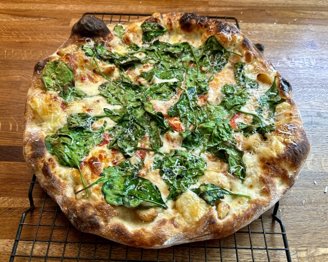 Puffy, blistered pizza with spinach and garlic