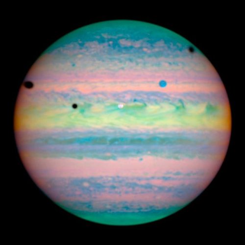 wonders-of-the-cosmos:In this composite image from near-infrared light, two of Jupiter’s moons are v