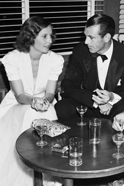 barbarastanwyck:  Barbara Stanwyck and Gary Cooper chatting at the Tailwagger’s dinner party benefit, 1938 