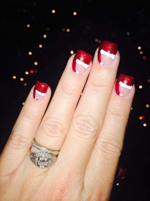 Got the inspo for this nail art from The Nail Network. Such a cute Santa hat french tip.