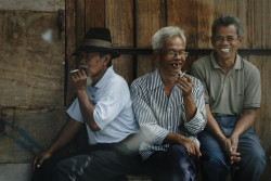 Three men smoking and laughing. Bandung,