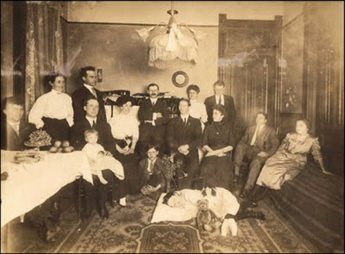 An entire family gathering to pose for the final picture of the deceased child.