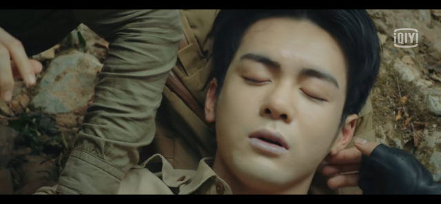 Wu Xie from Ultimate Note. He appears to have lost consciousness, and his lips are faintly blue. We can see Zhang Qilingms hand gently touching his ear and cheek