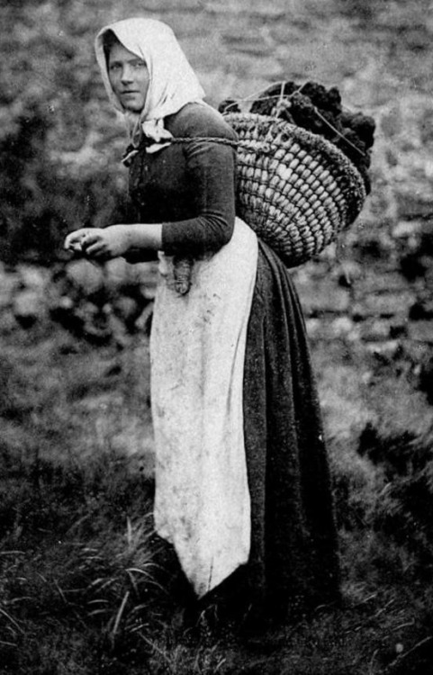 oldnorthwinds:‘Woman Crofter carrying a Peat basket’ ~ Isle of Harris.Crofting is a form of land ten