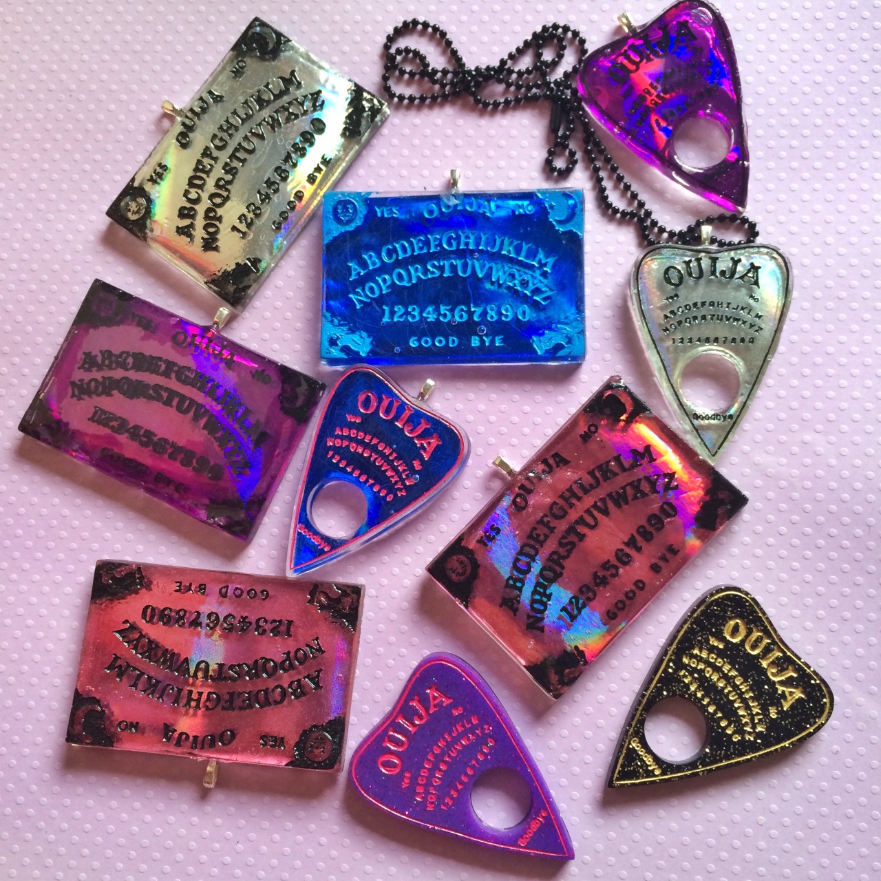 jinxandcurses:  NEW! Holographic ouija boards in planchettes in pink, purple, blue,