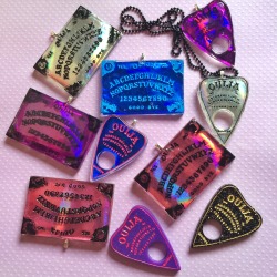 jinxandcurses:  NEW! Holographic ouija boards in planchettes in pink, purple, blue, and silver!https://www.etsy.com/shop/JinxAndCurses