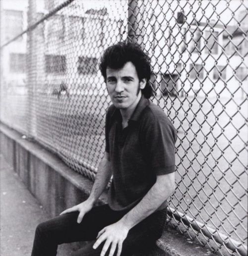 Bruce at the schoolyard fence, NY, August 1979 by Joel Bernstein